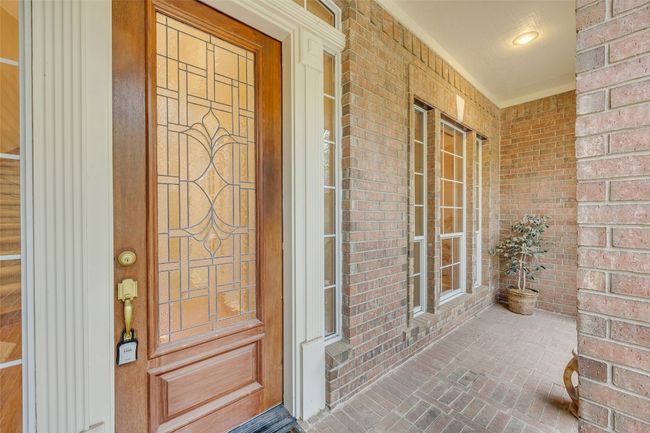 Entrance to property with covered porch and brick siding | Image 5