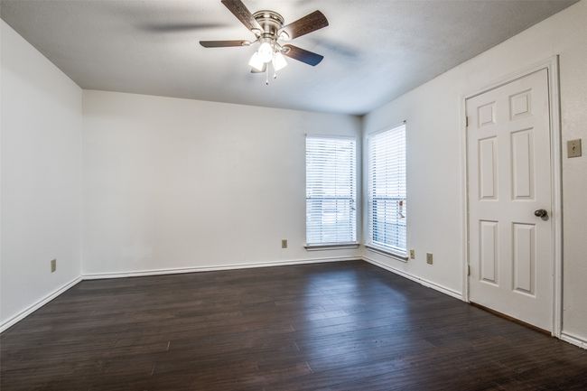 Spare room featuring a ceiling fan, dark wood-style flooring, and baseboards | Image 14
