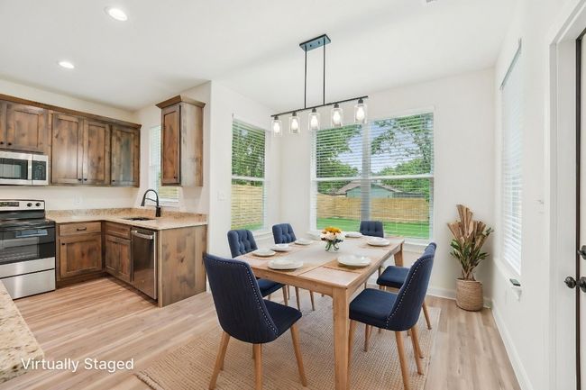 Virtually Staged Dining area with Vinyl Wood Plank floor, baseboards, and recessed lighting | Image 14