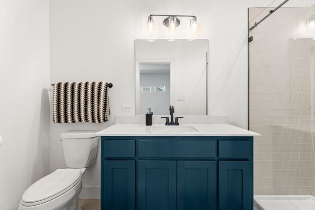 Bathroom featuring toilet, a stall shower, and vanity | Image 30