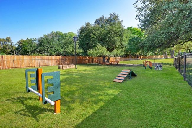 View of community featuring fence and a lawn | Image 12