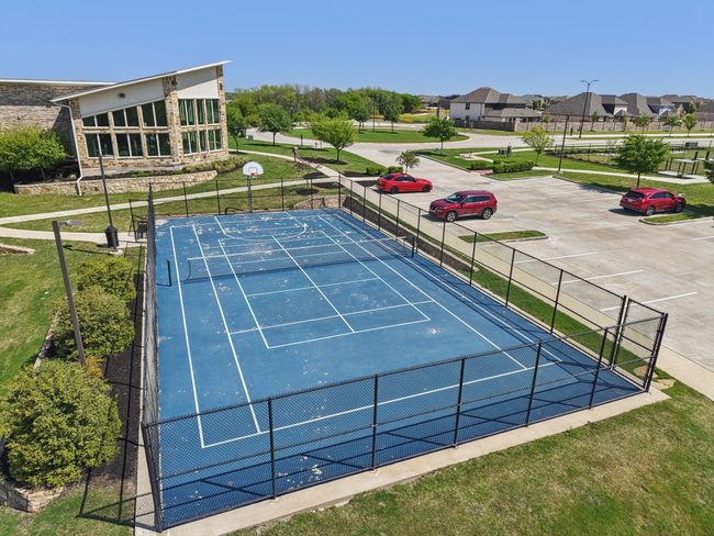 View of tennis court with community basketball court, fence, and a lawn | Image 39