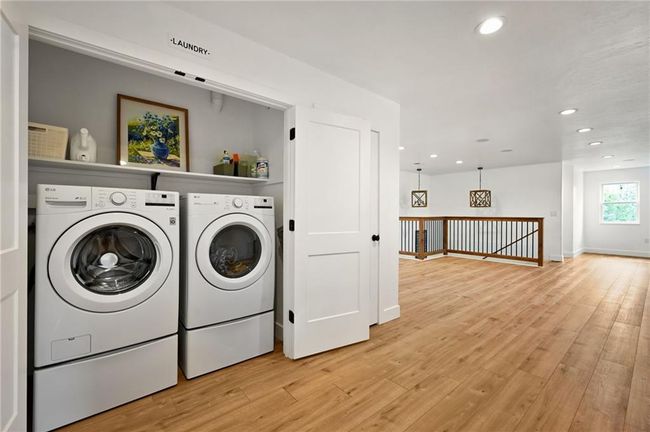 Laundry area with washing machine and clothes dryer, light wood finished floors, recessed lighting, and baseboards | Image 36