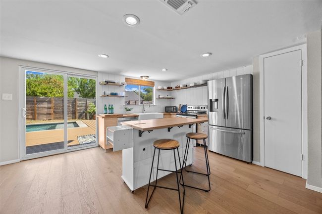 The kitchen opens to the dining room, living room and outside -- easy for entertaining! | Image 10