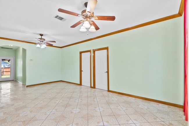 Empty room featuring arched walkways, ceiling fan, ornamental molding, and baseboards | Image 16
