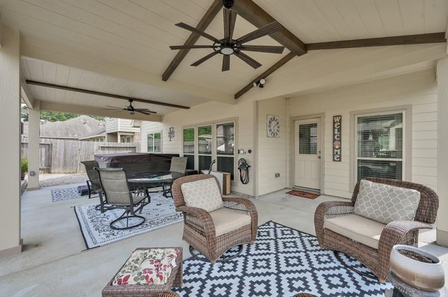 Generous covered patio offers an elegant outdoor retreat, ideal for dining al fresco or unwinding in the shade. | Image 33