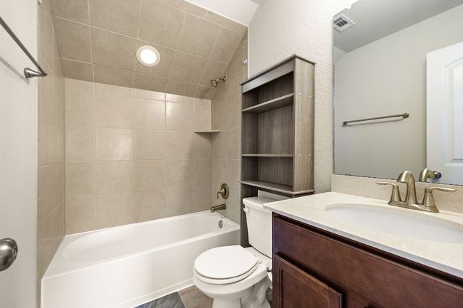 Full bathroom featuring visible vents, vanity, shower / tub combination, and toilet | Image 23