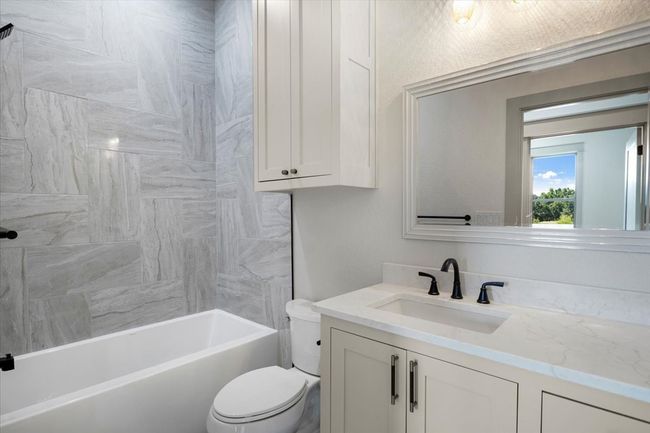 Bathroom with vanity and shower combination | Image 39