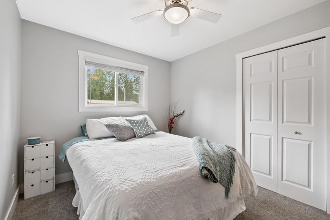 Bedroom with a closet, ceiling fan, carpet, and baseboards | Image 28