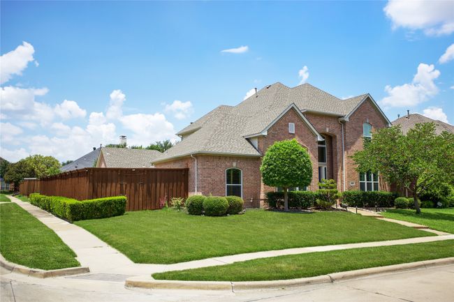 Traditional-style home with brick siding and a shingled roof | Image 36