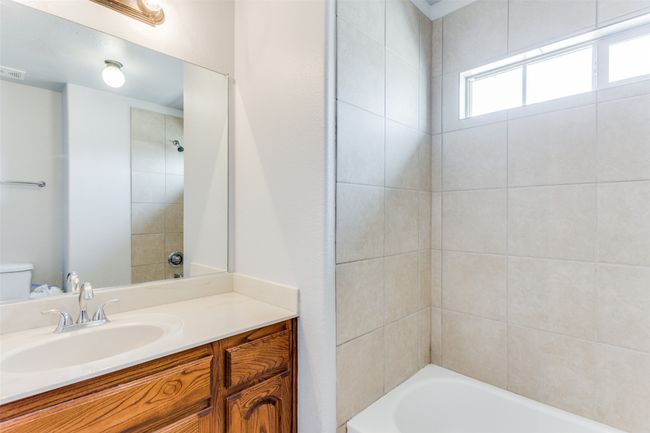 Bathroom featuring vanity and tub / shower combination | Image 31