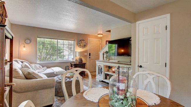 Dining area with wood finished floors and a textured ceiling | Image 9