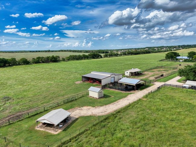 Aerial view of sparsely populated area featuring a pastoral area | Image 35