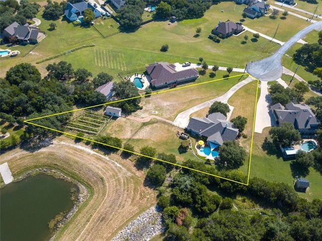 The property backs up to a lush green space with fishing pond, and an abundance of local wildlife. | Image 39