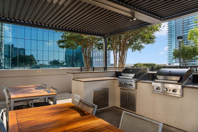 View of patio featuring area for grilling and outdoor dining area | Image 17