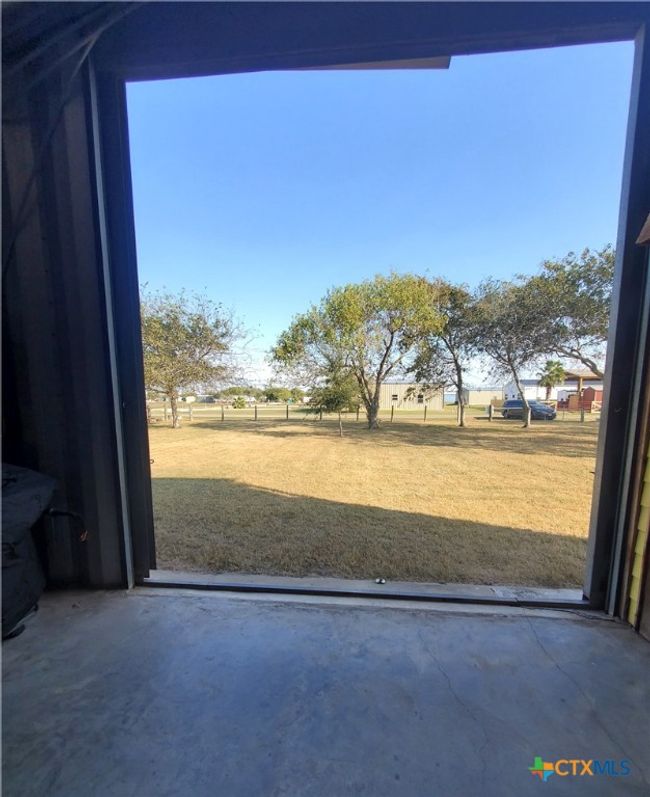 View of 13th St. & front yard from interior of garage. | Image 9