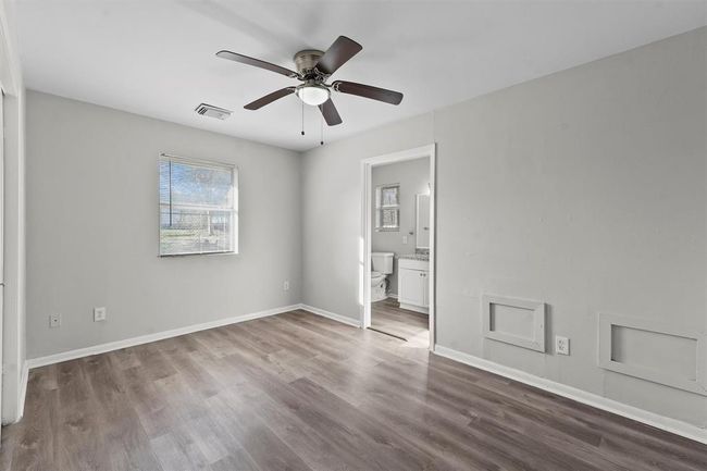 Walk into a bright primary bedroom with an en-suite. | Image 10