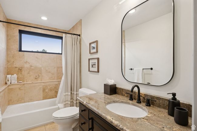 Bathroom featuring vanity, shower / bath combo, and tile patterned flooring | Image 62