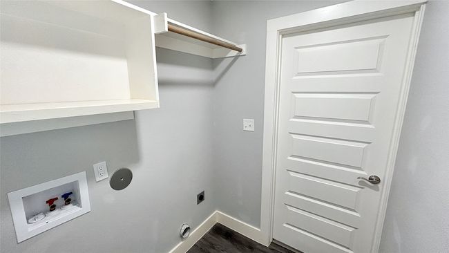 Laundry area with electric dryer hookup, hookup for a washing machine, and dark wood-style flooring | Image 13