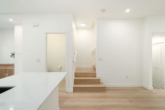 Stairs featuring baseboards, wood finished floors, and recessed lighting | Image 23