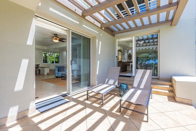 Easily move from the living area to the primary suite via the sliding doors that open to the lanai | Image 31