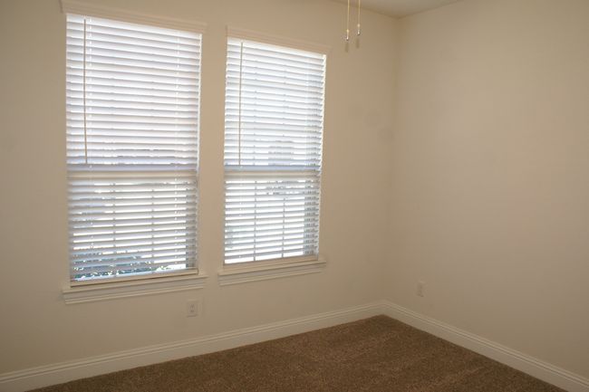 Bedroom with carpet flooring and a wealth of natural light | Image 6