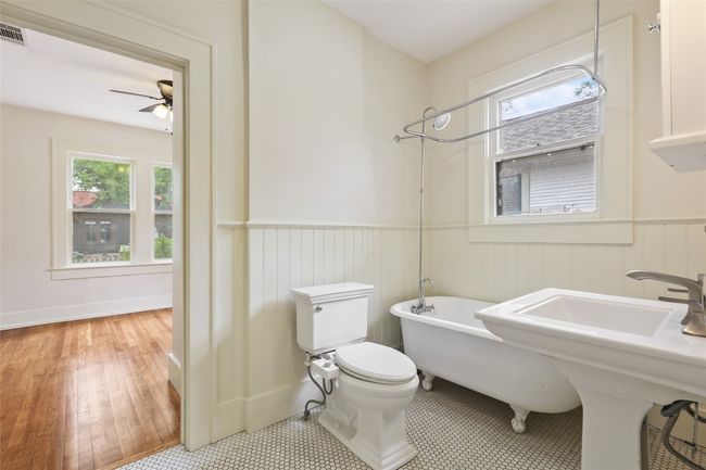 Full bath featuring wainscoting, a ceiling fan, and wood finished floors | Image 17