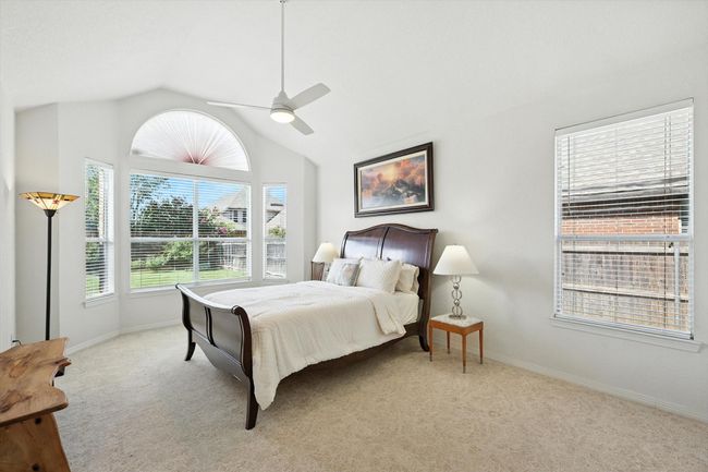 Bedroom featuring lofted ceiling, light carpet, and ceiling fan | Image 19