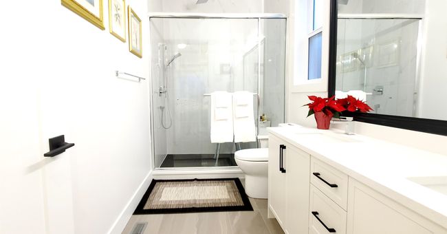 Bathroom featuring vanity, toilet, baseboards, and a stall shower | Image 27