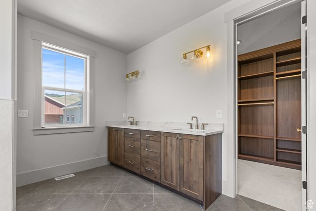 Full bath featuring double vanity and tile patterned flooring | Image 23