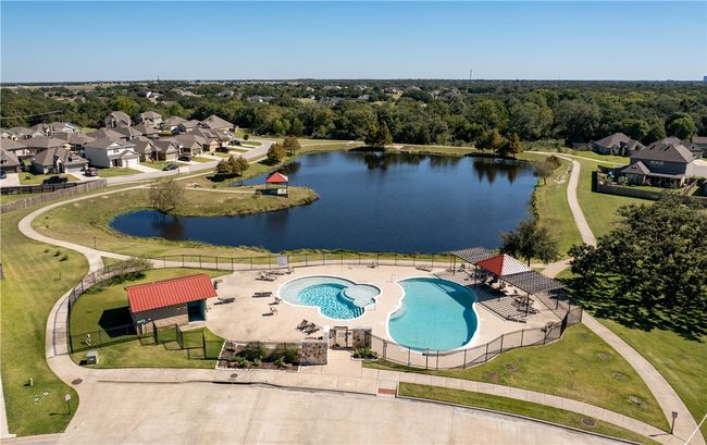 Drone / aerial view of a pool area and a nearby body of water | Image 18