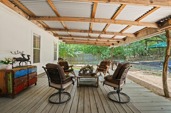 Covered wooden deck with outdoor lounge area | Image 19