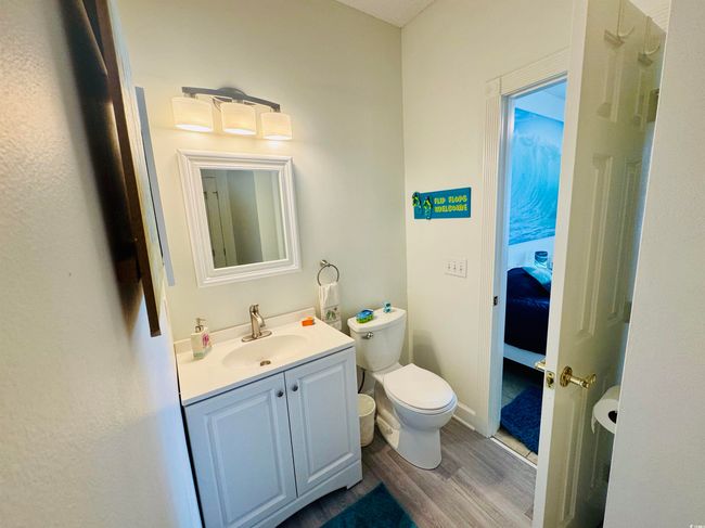Bathroom featuring wood finished floors, vanity, and toilet | Image 15