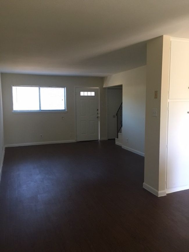 Entrance foyer with dark wood finished floors, stairs, and baseboards | Image 20