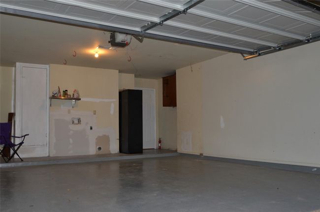 Garage with a garage door opener | Image 11