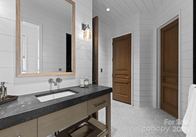 The poolside bath is equipped with a walk-in shower, water closet, storage closet, and a drop zone from the pool. | Image 39
