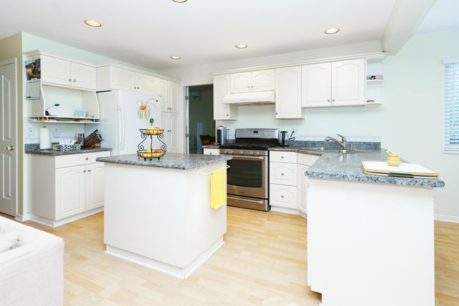 Kitchen featuring open shelves, stainless steel gas stove, freestanding refrigerator, under cabinet range hood, and a sink | Image 7