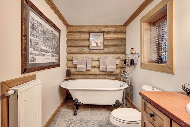 Bathroom with log walls, radiator heating unit, vanity, a freestanding tub, and ornamental molding | Image 21