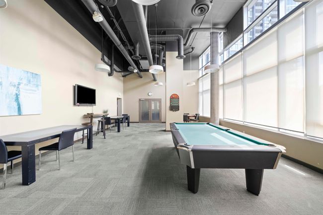 Rec room with carpet flooring, a high ceiling, healthy amount of natural light, billiards, and baseboards | Image 25