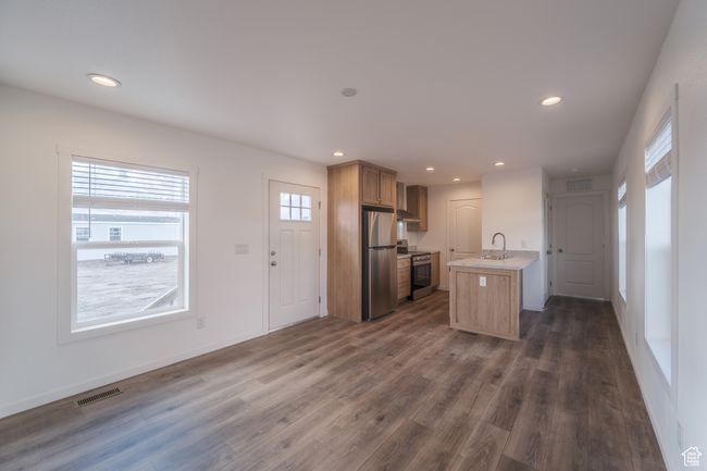 Kitchen with visible vents, dark wood finished floors, light countertops, appliances with stainless steel finishes, and a sink | Image 6