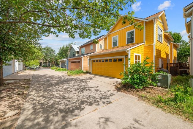 The attached 2-car garage with alley access offers both convenience and privacy | Image 34