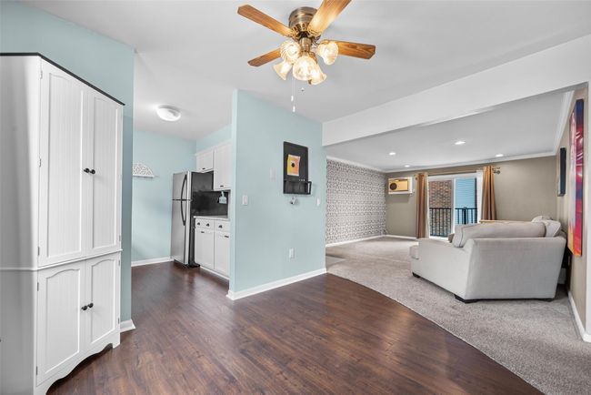 Living room with ceiling fan, dark wood finished floors, and recessed lighting | Image 12