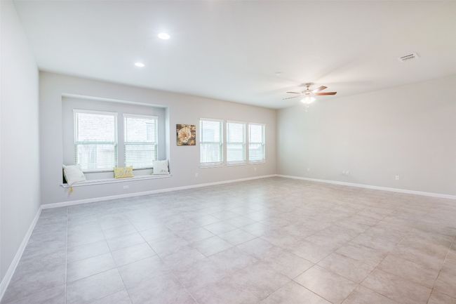 Empty room with visible vents, baseboards, and a ceiling fan | Image 12