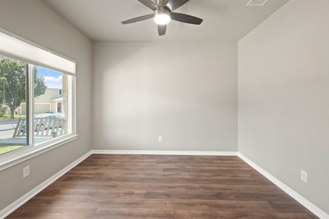 Unfurnished room featuring ceiling fan, wood finished floors, and baseboards | Image 10