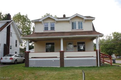 View of front facade with a front yard and a porch | Image 1