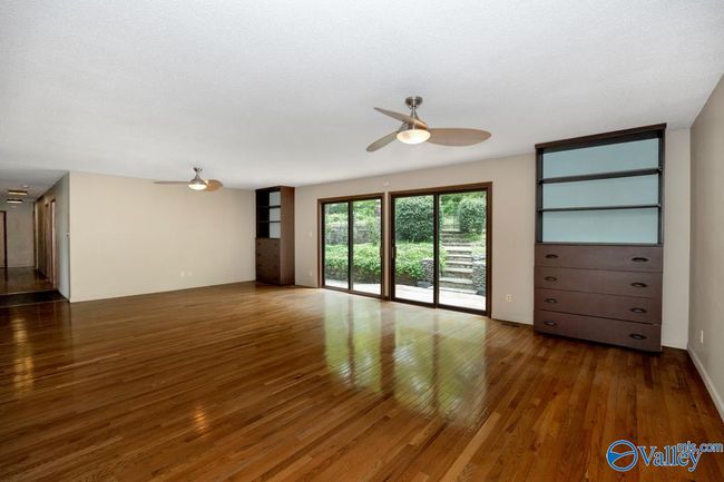 Huge family room with sliding doors to backyard and stone patio | Image 5