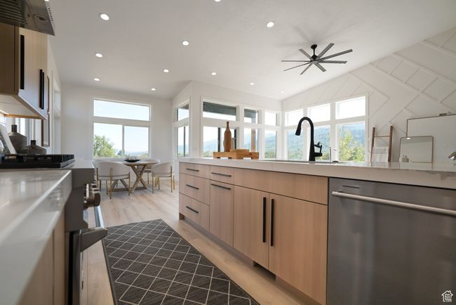 Kitchen with stainless steel dishwasher, modern cabinets, light brown cabinets, light countertops, and recessed lighting | Image 4