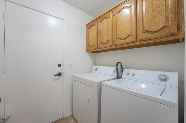 Laundry room featuring built in cabinets | Image 21
