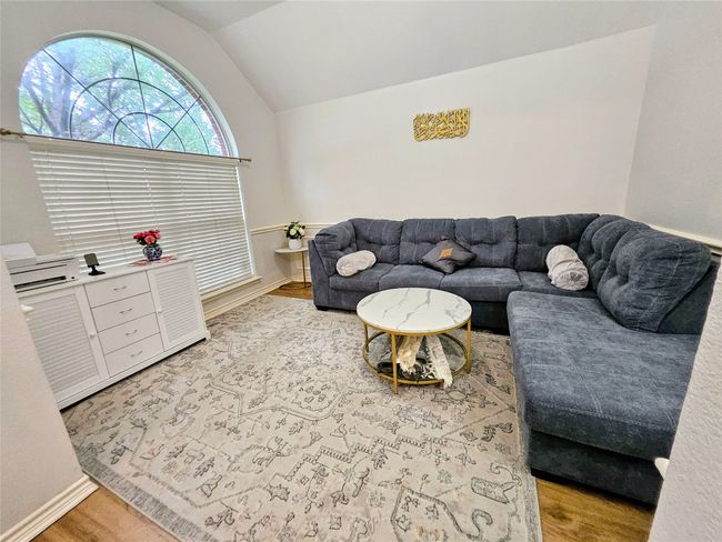 Living room with lofted ceiling and light wood-type flooring | Image 14