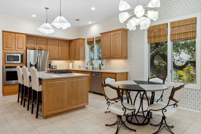 Enjoy entertaining in kitchen while guests lounge at the center island, or enjoy a casual breakfast in the breakfast area. | Image 11